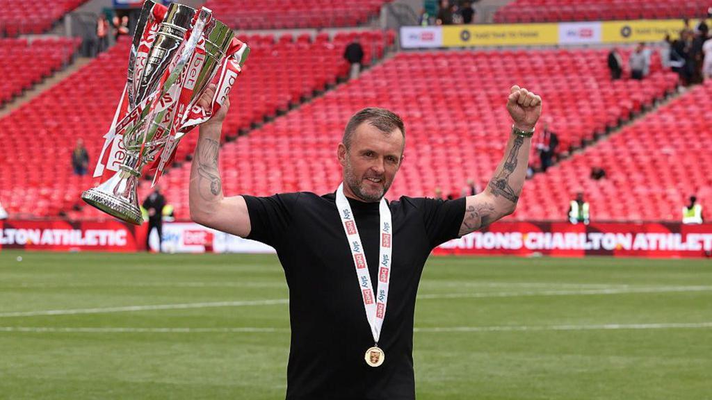 Nathan Jones lifts the League One play-off final winners' trophy