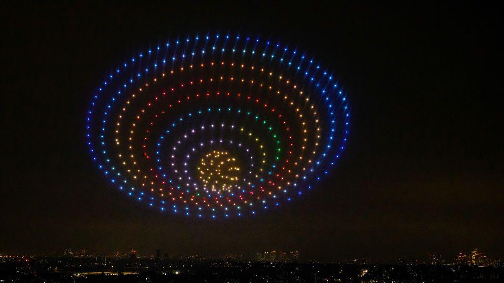 We can see different coloured concentric circles in the dark night sky.
