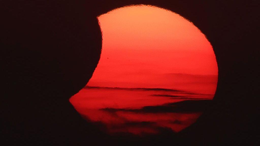 The Moon uncovers the Sun in the moments following totality of the solar eclipse as seen from La Zurriola beach in San Sebastian.