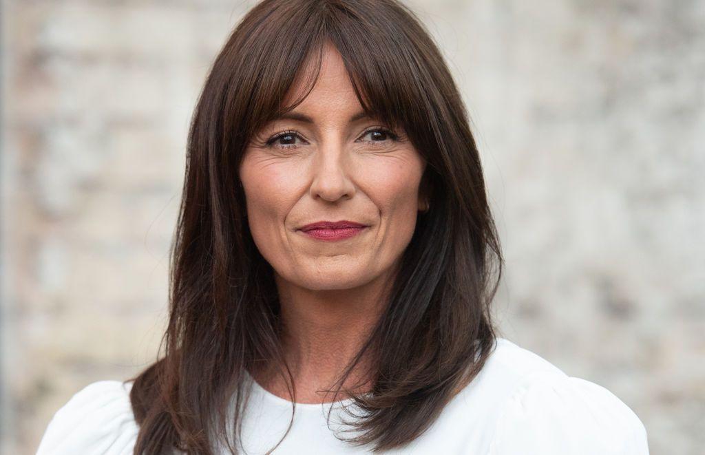 Davina McCall wearing white and looking ahead