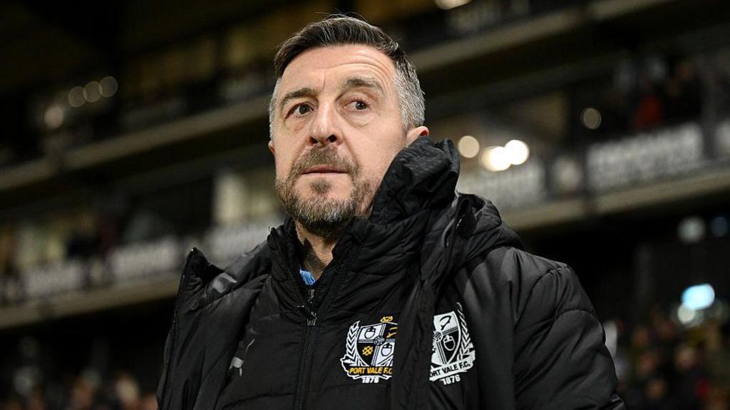 Port Vale manager Jon Brady watches on from the touchline