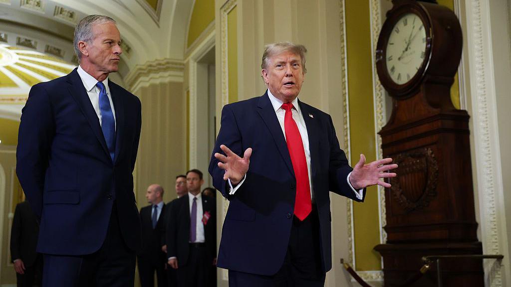 Senate Majority Leader John Thune (L) and US President Donald Trump (R) speak to reporters at the Capitol.