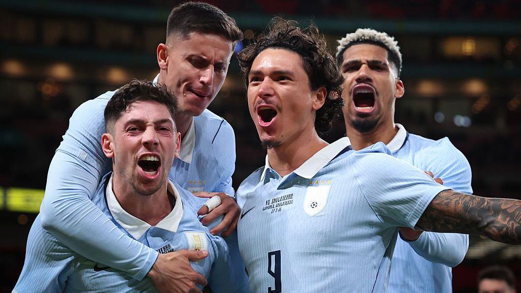 Federico Valverde of Uruguay celebrates scoring with Darwin Nunez and Ronald Araujo