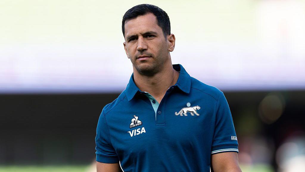 Argentina international Matías Moroni walks out on a pitch before a game.