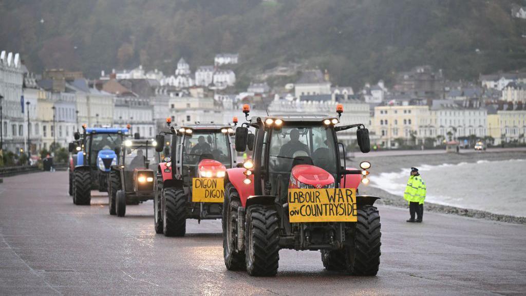 Tractors on the promenade at Llandudno with a sign Labour War on Countryside 