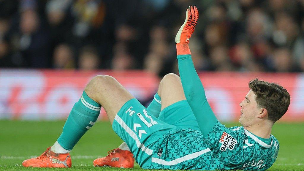 Sunderland goalkeeper Melker Ellborg lies injured during the Premier League match against Leeds United at Elland Road