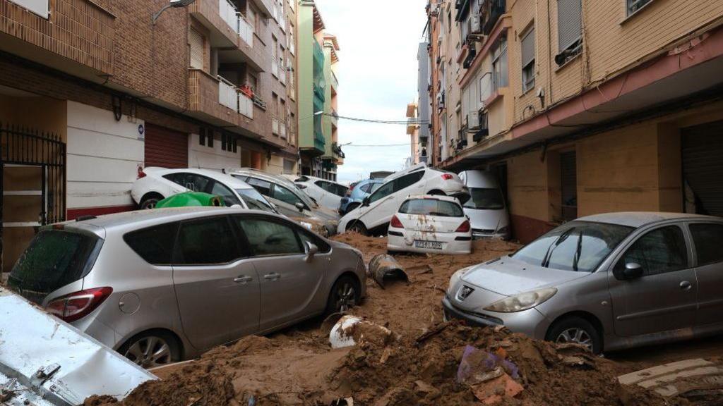 Cars piled up in the street after floods hit Valencia