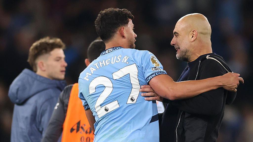 Pep Guardiola speaks with Matheus Nunes