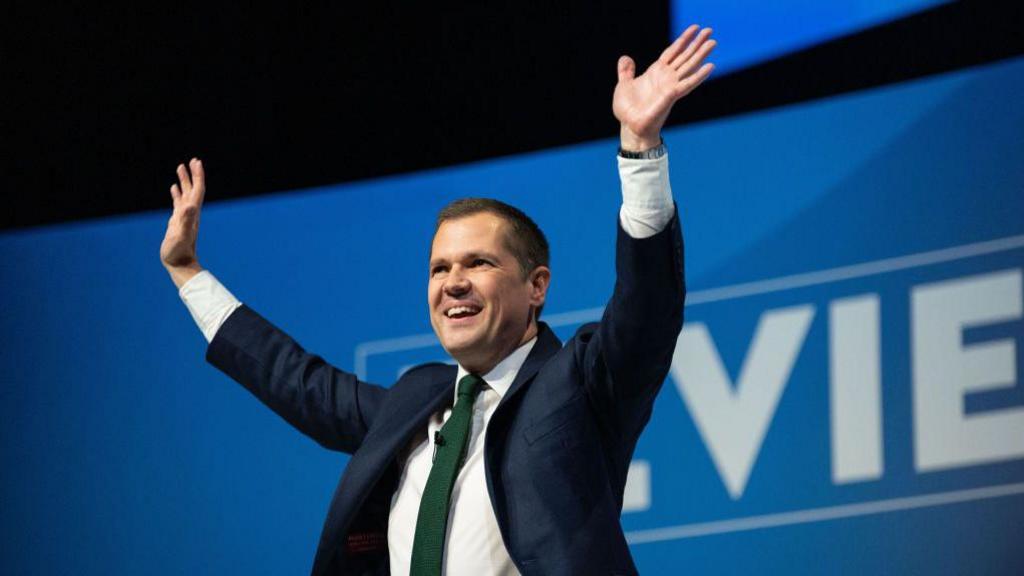 Robert Jenrick waving on stage after delivering his speech to the Conservative Party conference in Birmingham 