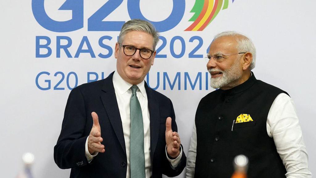 UK's Prime Minister Keir Starmer (L), who is wearing a black suit with white shirt and a teal tie, and India's Prime Minister Narendra Modi, who is wearing a black jacket with white shirt, talk during a bilateral meeting in the sidelines of the G20 summit at the Museum of Modern Art in Rio de Janeiro, Brazil Brazil, on November 18, 202