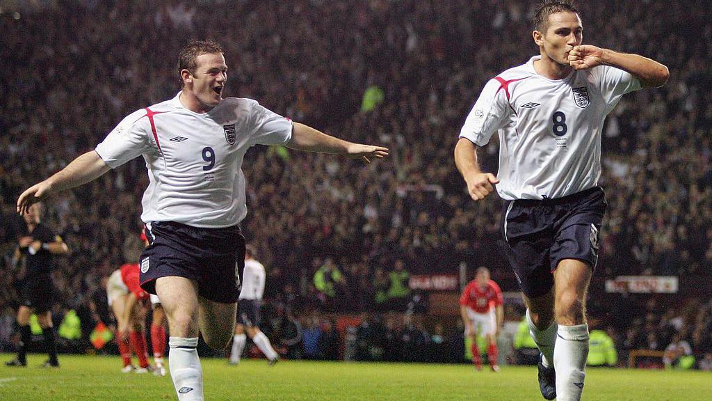 Wayne Rooney and Frank Lampard wearing England kits celebrating together