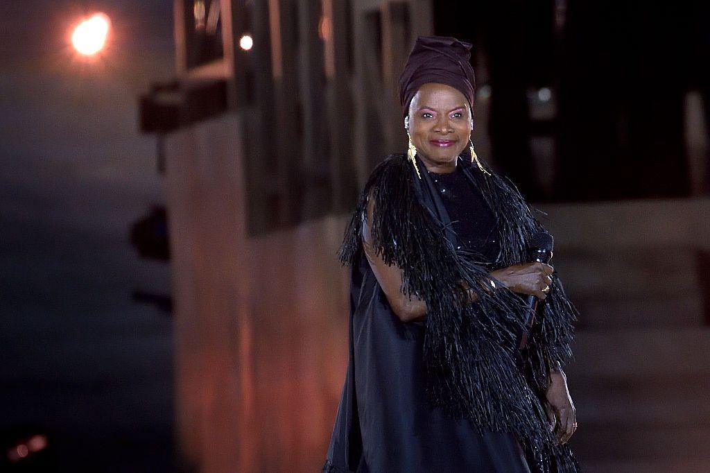 Beninese singer Angélique Kidjo smiles on stage.