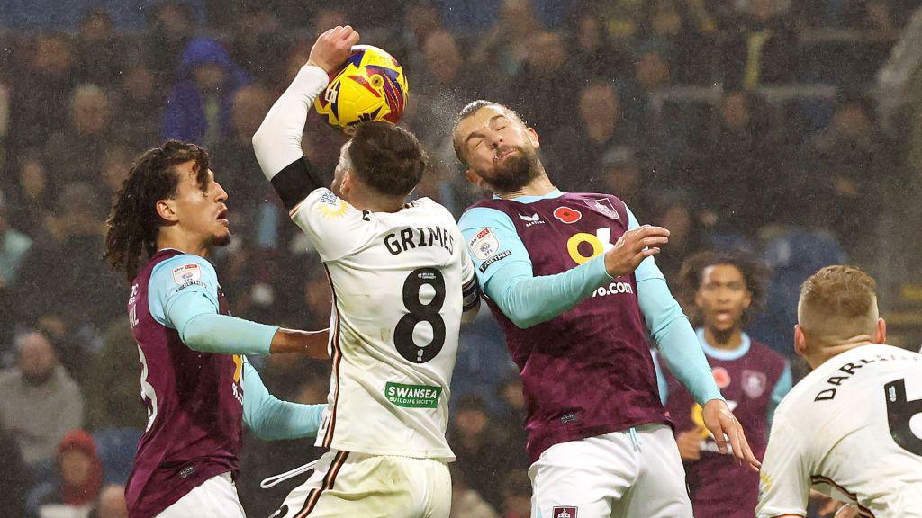 The ball hits the hand of Swansea captain Matt Grimes