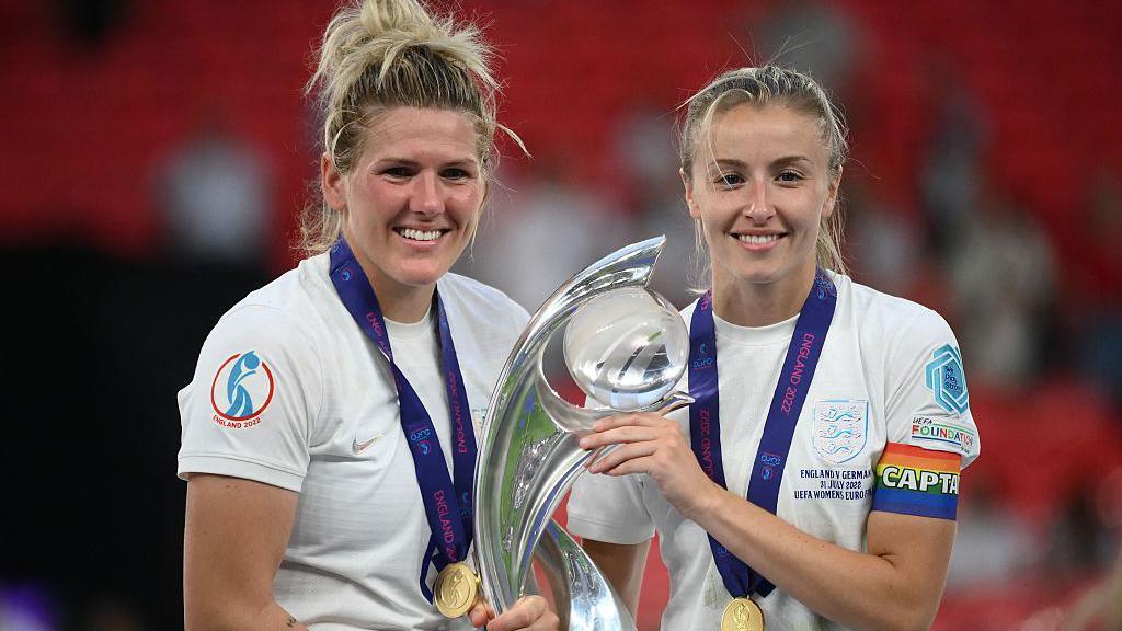 Millie Bright and Leah Williamson with the Euro 2022 trophy
