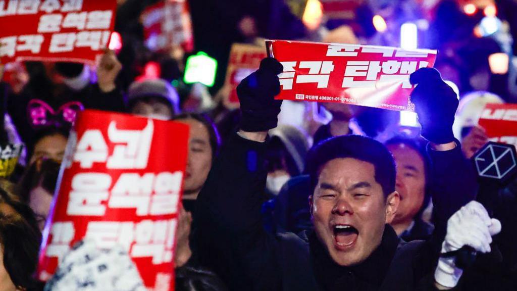 People take part in a rally featuring K-POP musics to protest against South Korean Yoon Suk Yeol, after the parliament passed a bill to appoint a special counsel to investigate Yoon over his failed attempt to impose martial law, near the National Assembly, in Seoul, South Korea, on 10 December, 2024. 