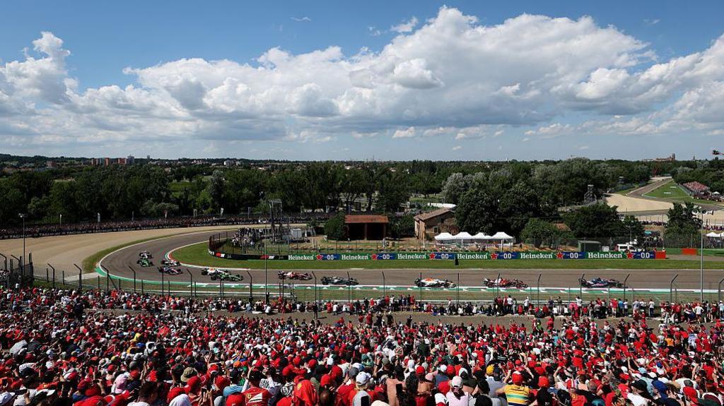 Cars pass fans at the 2025 Emilia-Romagna Grand Prix in 2025 