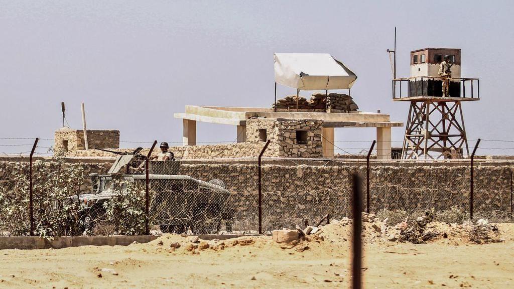 An Egyptian soldier standing guard in a watch tower, seen from the Gaza city of Rafah (file image)