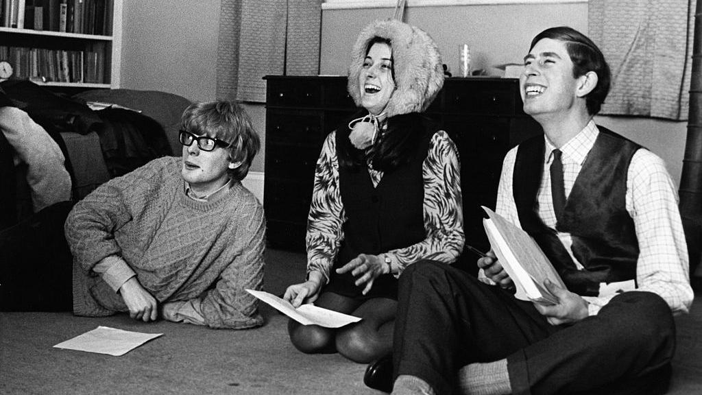 Charles sits on the floor of a college room rehearsing for a play 