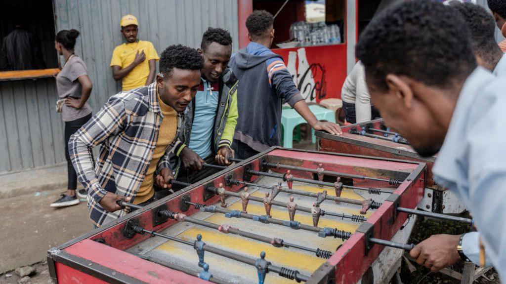 An image of Ethiopian men playing foosball in the capital Addis Ababa on 27 July 2024.