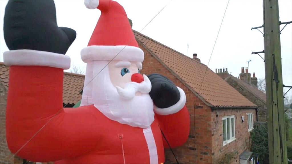 Huge inflatable Santa bigger than house