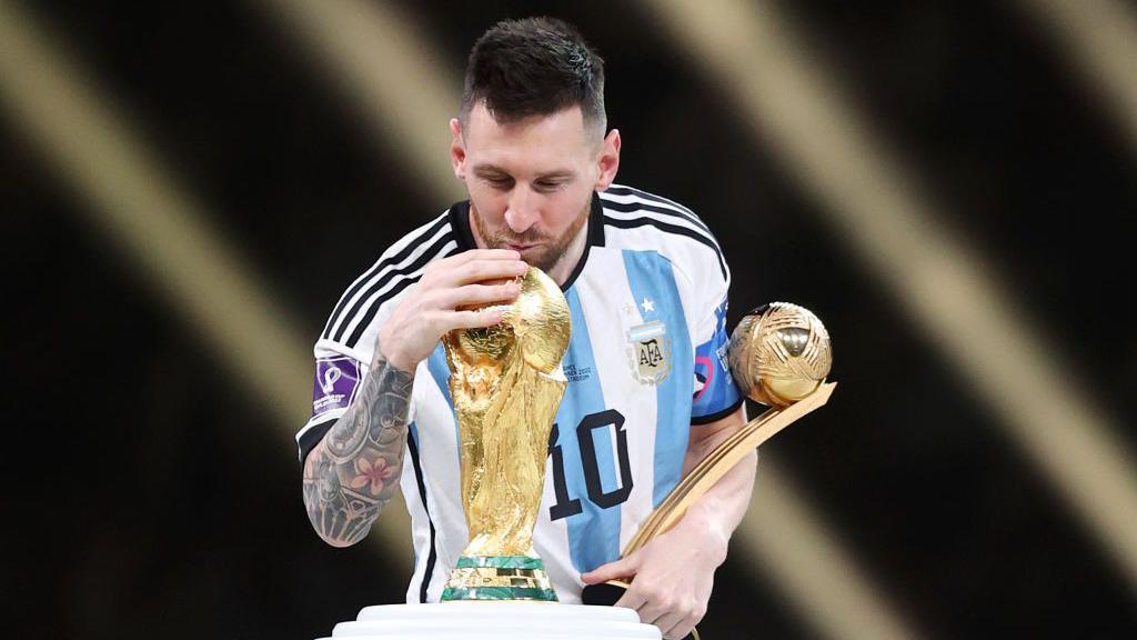 Argentina captain Lionel Messi kisses the World Cup