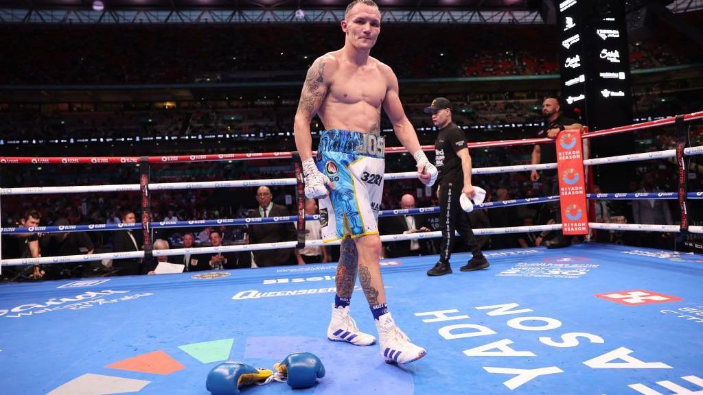 Jos Warrington leaves his gloves in the ring after his defeat by Anthony Cacace at Wembley in September 2024