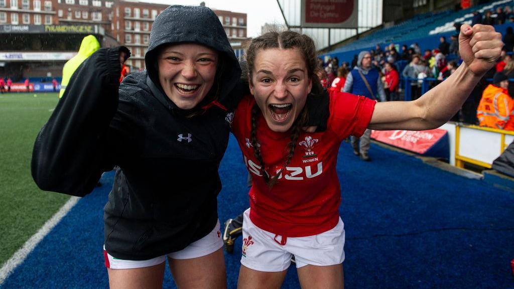 Alisha Joyce-Butchers [left] and Jasmine Joyce-Butchers [right] celebrate after playing for Wales