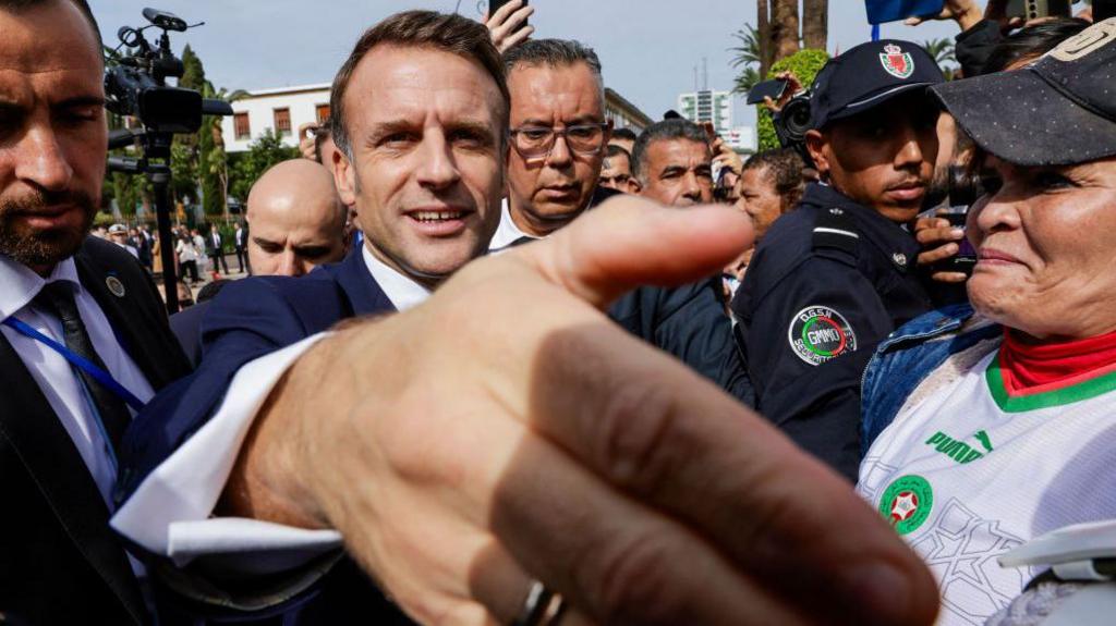 France's President Emmanuel Macron greets people outside the parliament in Rabat on 29 October.