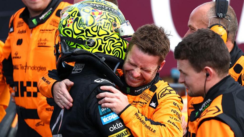 Lando Norris celebrates winning the British Grand Prix with a McLaren mechanic