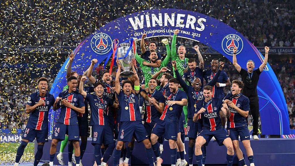 PSG lifting the Champions League trophy.