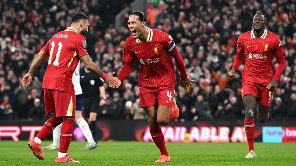 Virgil van Dijk celebrates with Mo Salah after scoring Liverpool's fourth goal.