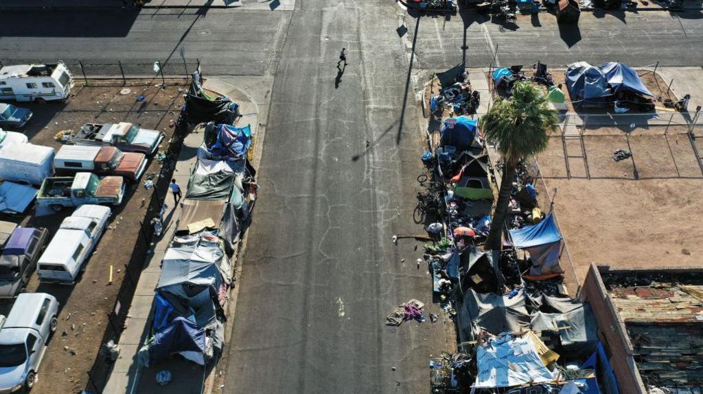 Aerial view of tents scattered along a road