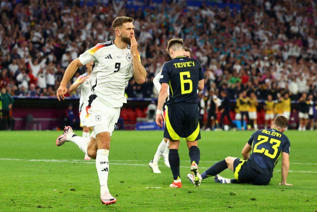 Niclas Fullkrug celebrating near Scotland players.