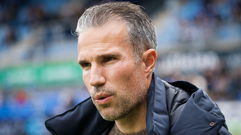 Close up of Robin van Persie wearing a thick coat 