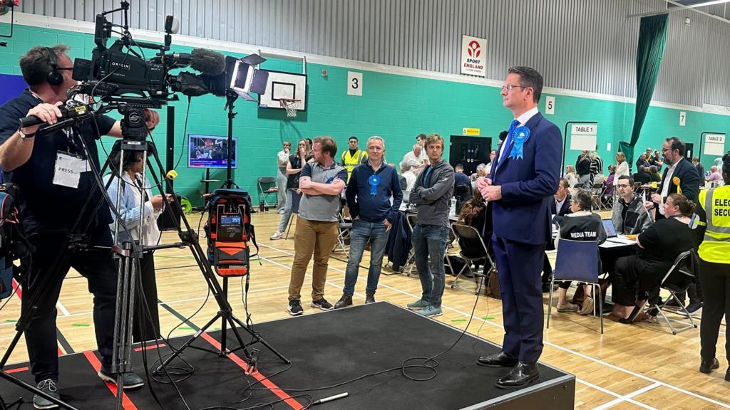 Steve Baker being interviewed on a platform at the Wycombe general election count 2024