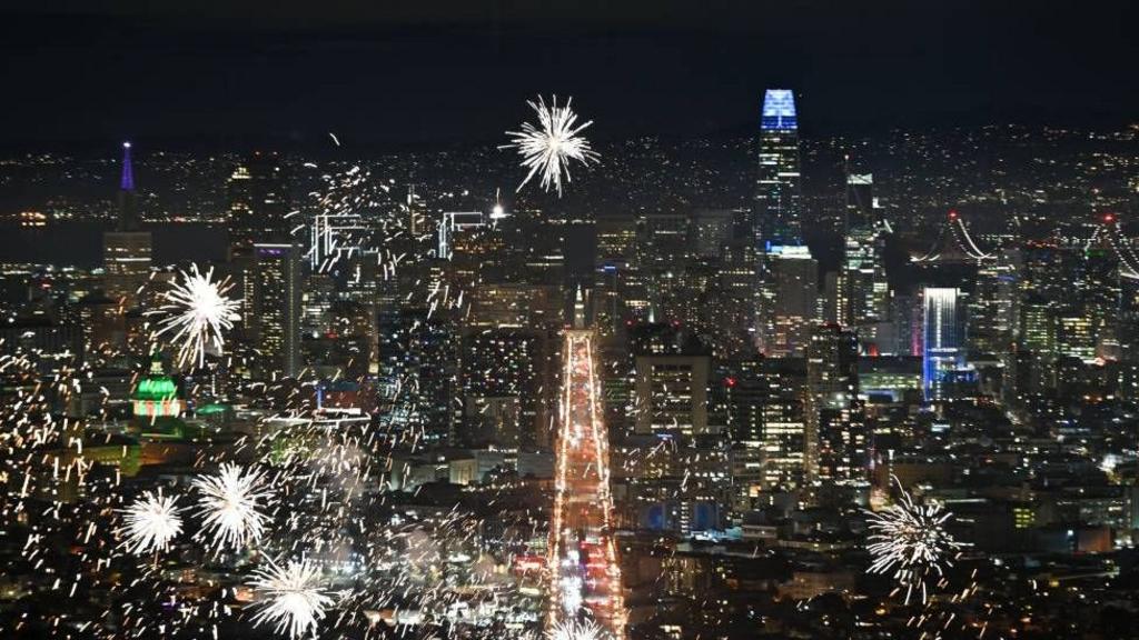 San Francisco is lit up with fireworks against a darkened background.