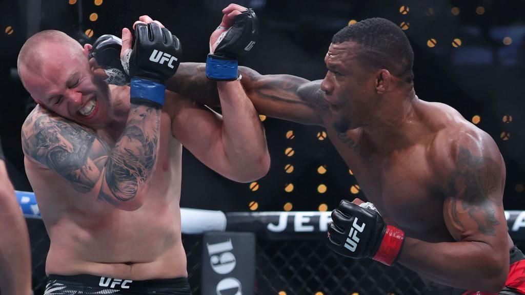 Jailton Almeida punches Serghei Spivac in the face