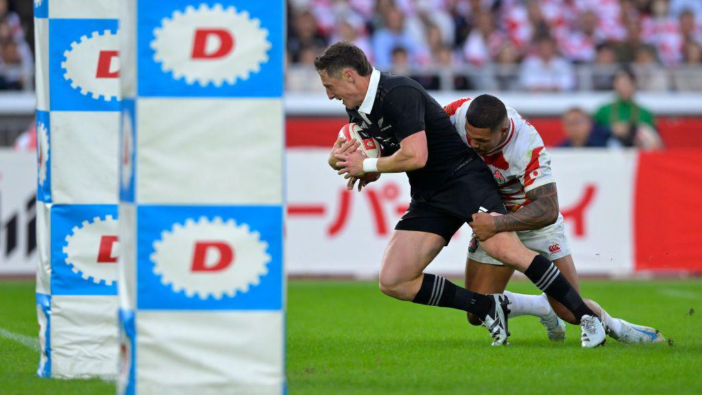 Cam Roigard score a try against Japan