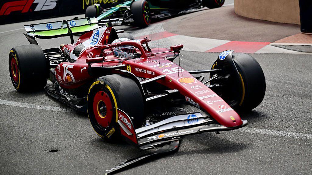 Charles Leclerc drives with a damaged front wing during the first practice session