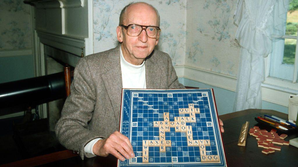 Alfred posing with a scrabble board