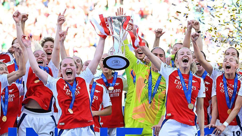 Arsenal's players lift the Women's Champions League trophy