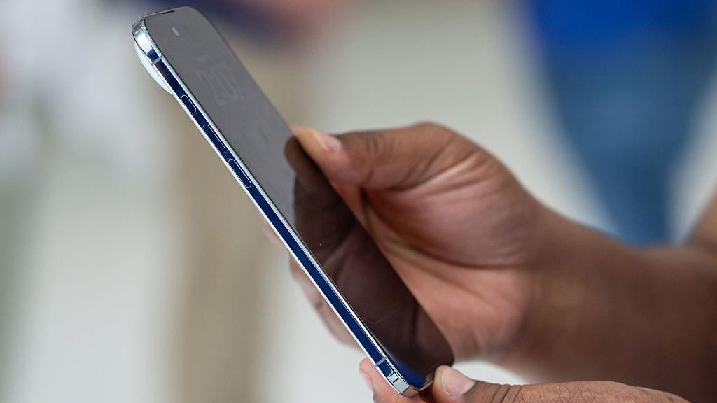 A person holding the Apple iPhone Air