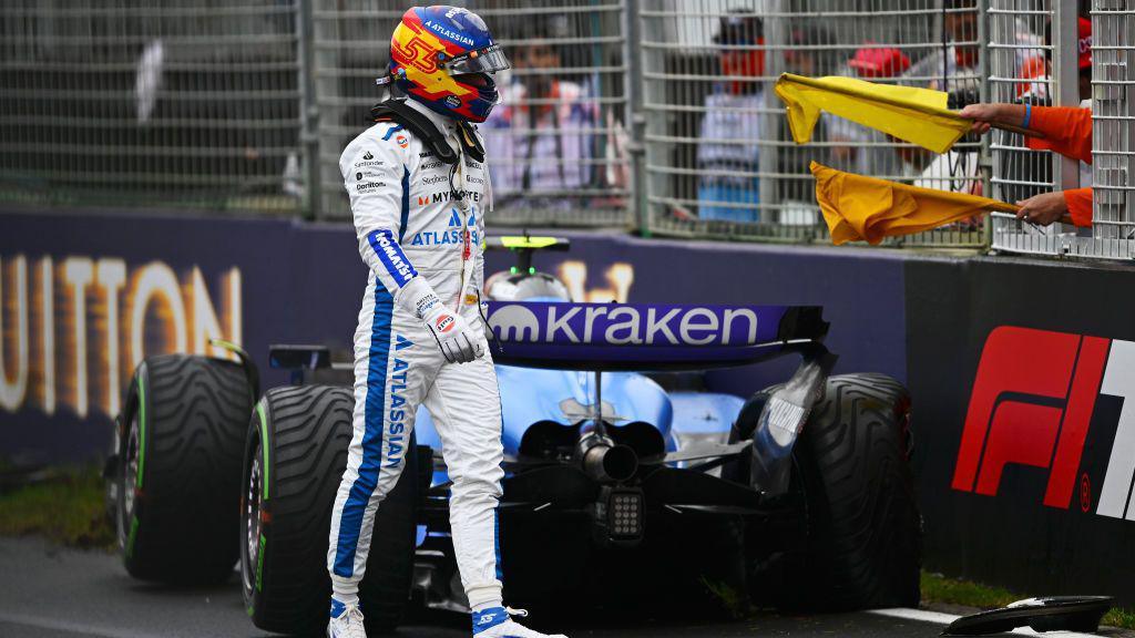 Carlos Sainz walks away from his car after crashing.