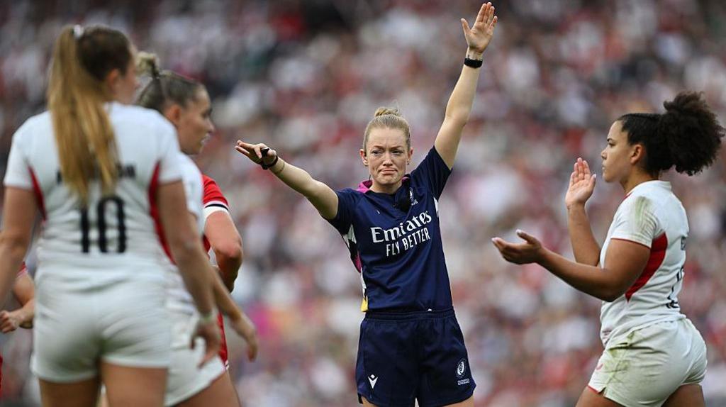 Referee Hollie Davidson signals for a penalty to England during the Women's Rugby World Cup 2025 Final match between Canada and England at Allianz Stadium on September 27, 2025 in London, England.