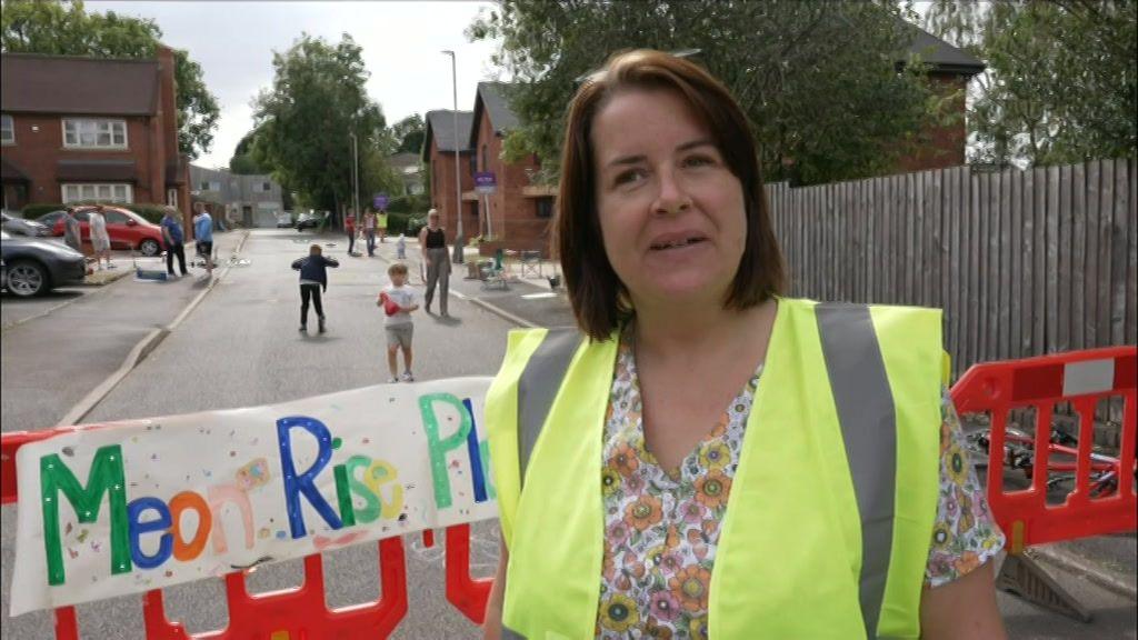 Ruth Blayney is pictured with short brown hair with grey roots. She is wearing a yellow hi-vis jacket.
