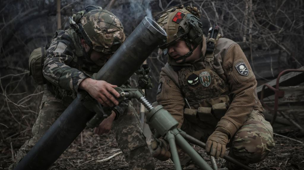 Ukrainian soldiers fire a mortar in Donetsk