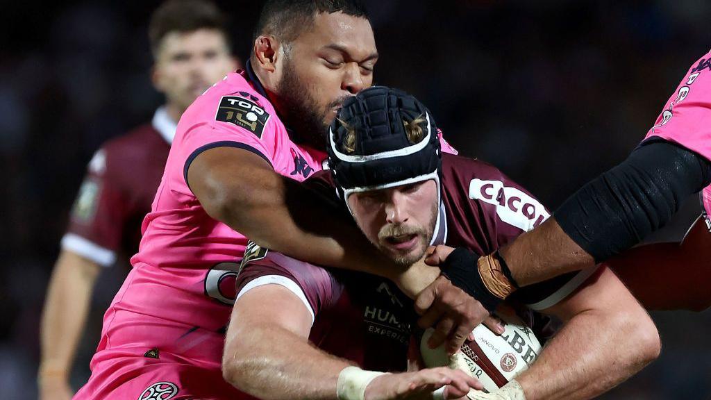 Bordeaux-Begles' Scottish lock Jonny Gray is tackled by Paris' Australian prop Moses Eneliko Alo Emile (up) during the French Top14 rugby union match between Union Bordeaux-Begles (UBB) and Stade Francais Paris at The Chaban-Delmas Stadium in Bordeaux, south-western France on September 7, 2024. 