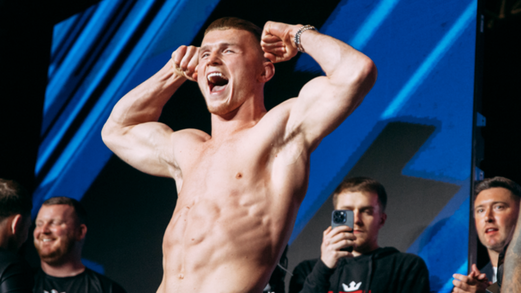 Paul Hughes smiles and shouts weighing in