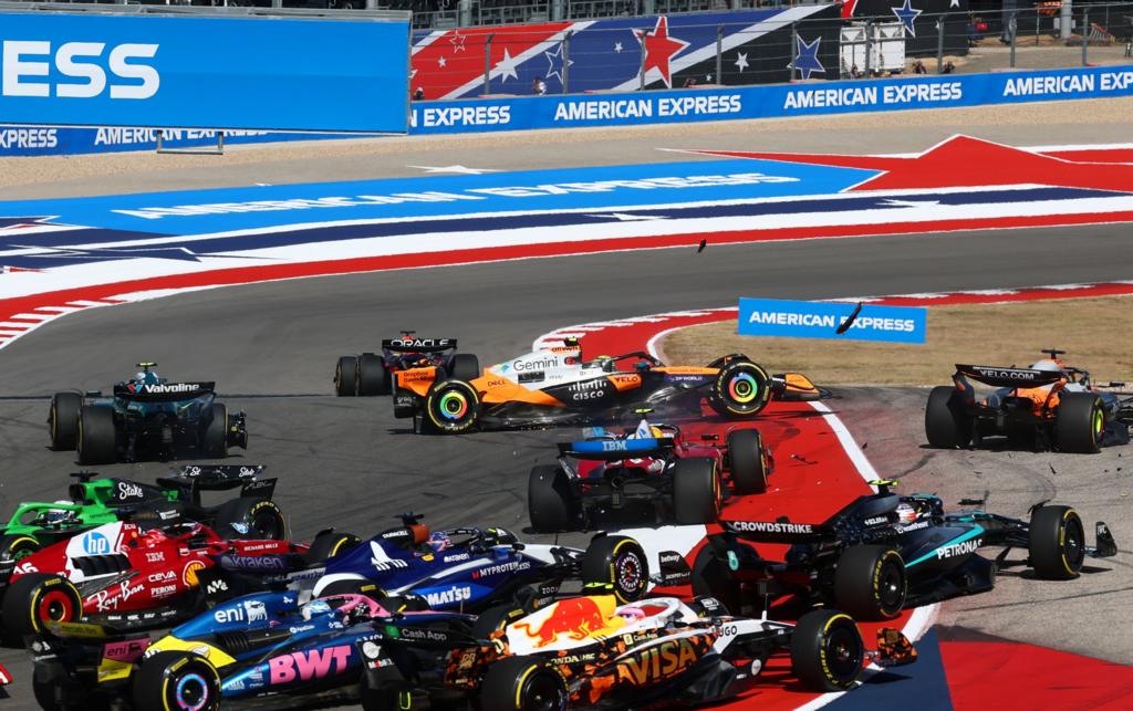 Cars converge at the first corner of the US grand Prix sprint race, with debris on the circuit after the McLarens of Lando Norris and Oscar Piastri collided