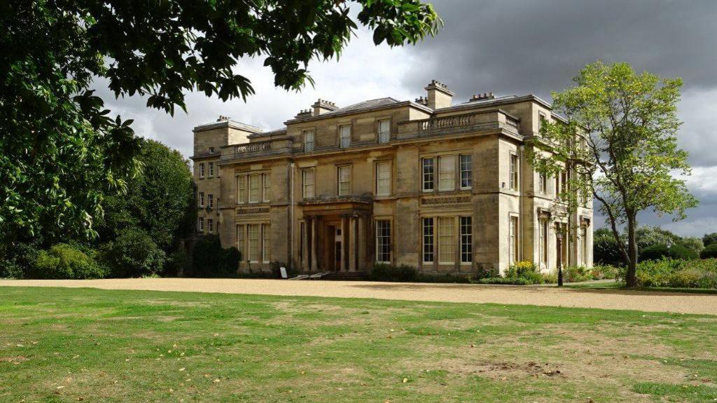 Normanby Hall with its gravel driveway and mowed lawns in the sunshine.